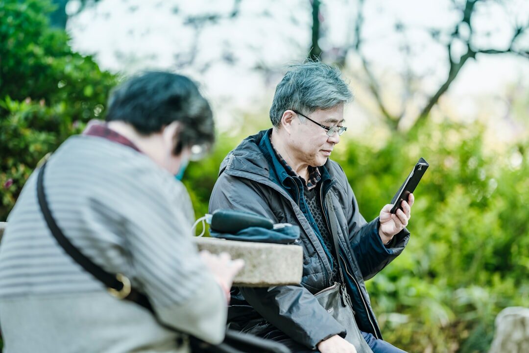 Senior woman learning to use a tablet with a young volunteer helping