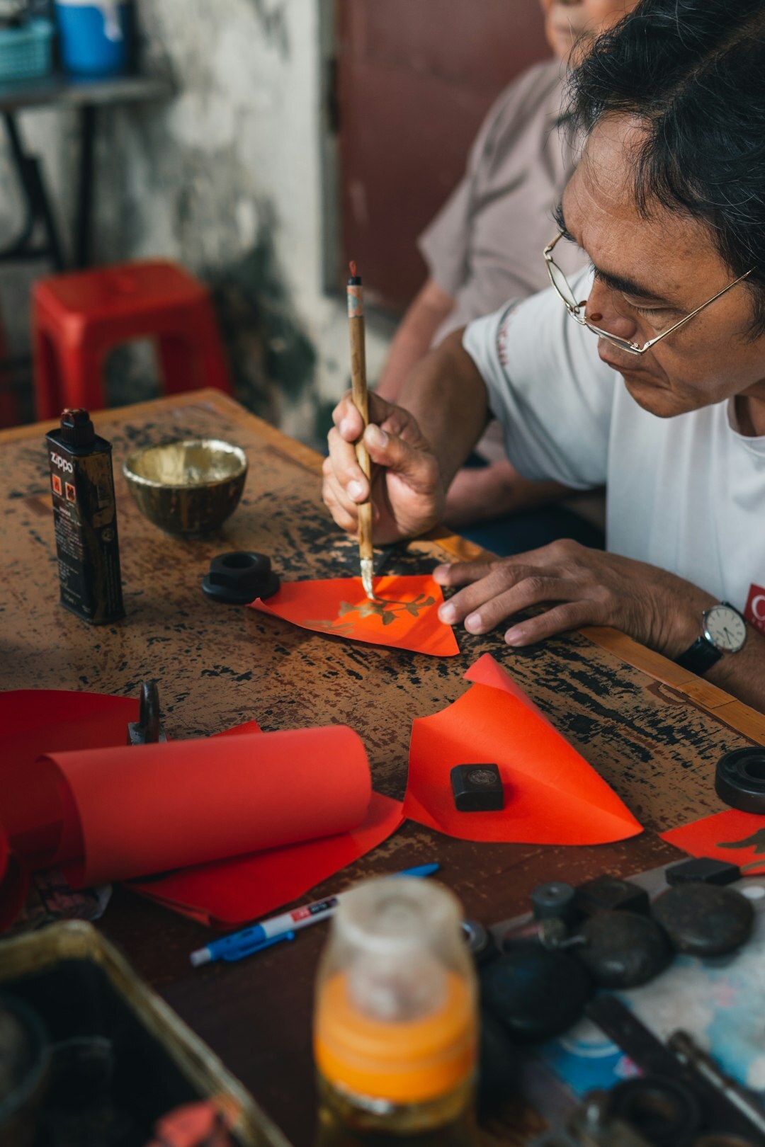 Elderly people painting and doing crafts together at a table